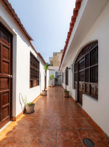 a corridor of a building with a door and a courtyard at Hotel Country Trujillo in Trujillo
