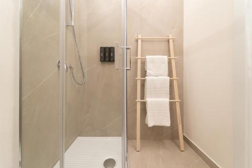 a bathroom with a shower with a towel rack at Kondo Maisons in Catania