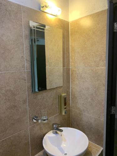 a bathroom with a sink and a mirror at Hotel La Casa del Capi in Holbox Island