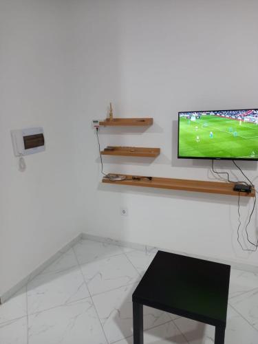 TV a/nebo společenská místnost v ubytování Figo Apartamentos
