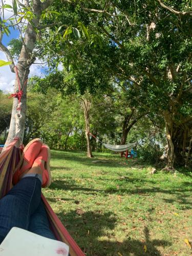 a person sitting on a hammock in a park at Campito Loving in Higuey