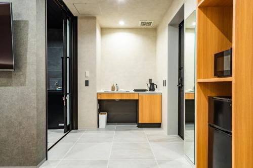 a kitchen with a sink and a counter at Randor Hotel Hiroshima Prestige in Hiroshima