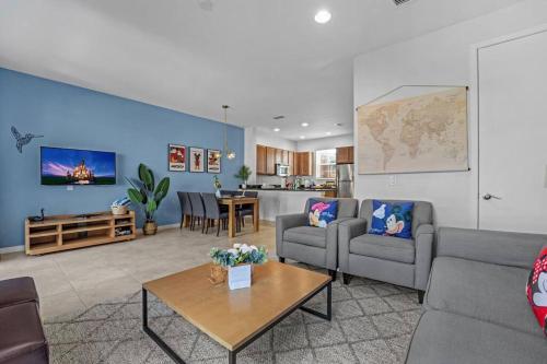a living room with two couches and a table at Find your Cozy home 8 minutes near Disney and Universal in Orlando