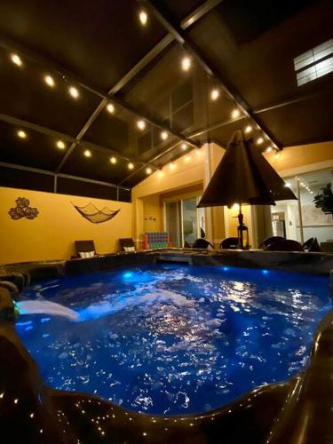a large pool of blue water in a room at Find your Cozy home 8 minutes near Disney and Universal in Orlando