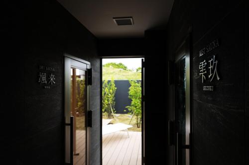 a hallway with a door leading to a patio at Garden Terrace Nagasaki Hotels & Resorts in Nagasaki
