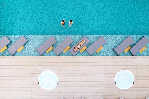 an overhead view of a pool with people in the water at Garden Terrace Nagasaki Hotels & Resorts in Nagasaki