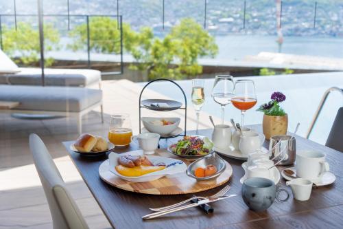 a table with plates of food and glasses of wine at Garden Terrace Nagasaki Hotels & Resorts in Nagasaki