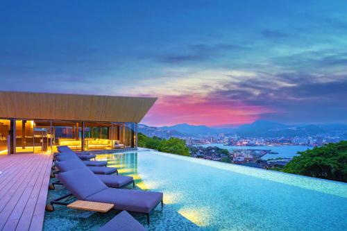 a pool at a hotel with a view of the city at Garden Terrace Nagasaki Hotels & Resorts in Nagasaki