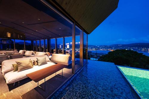 a bedroom on the roof of a house with a view at Garden Terrace Nagasaki Hotels & Resorts in Nagasaki