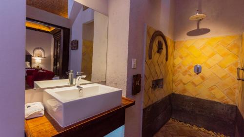 a bathroom with a white sink and a shower at Casa Eva Hotel Boutique & Spa in Cholula