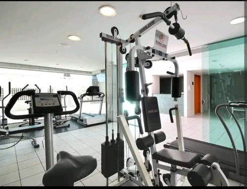 a gym with several tread machines in a room at Hotel Lider à 1km da Esplanada dos Ministérios in Brasília