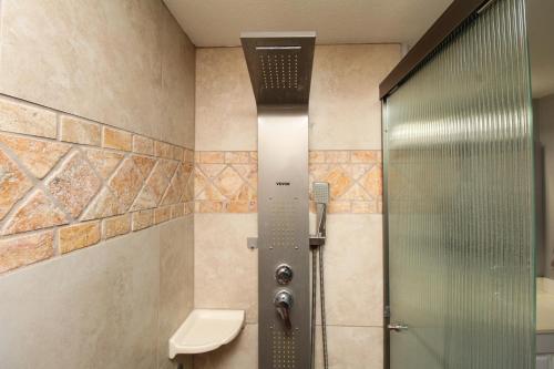 a shower with a glass door in a bathroom at Luxurious Scottsdale Guesthouse by the Pool in Phoenix