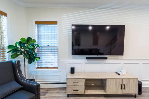 a living room with a tv on a wall at Luxurious Retreat, Parking, Restaurants, Near New Hope, 1mile Delaware River in Lambertville