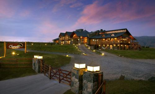 a large house on a hill with a fence at Chamonix Posada & Spa in Villa General Belgrano