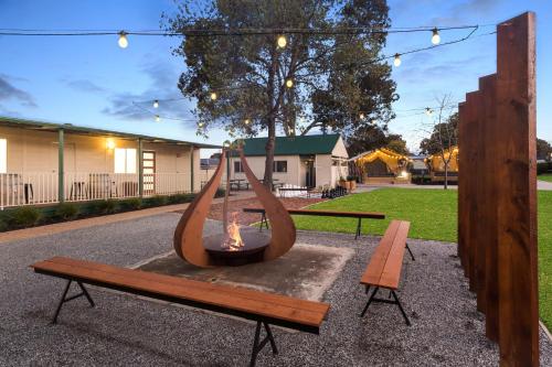 a fire pit with a bench and a fire hydrant at BIG4 Tasman Holiday Parks - Bendigo in Bendigo