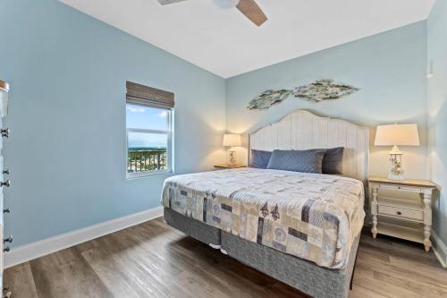a bedroom with a large bed and a window at Beautiful Panama City Beach Condo- Ocean View! in Panama City Beach