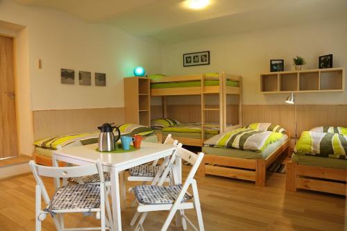 a room with a table and chairs and bunk beds at Ubytování v soukromí U Volného in Příbor