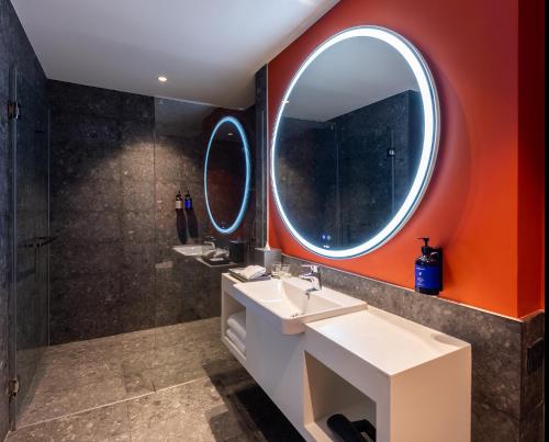 a bathroom with two sinks and a large mirror at Travelodge Nimman in Chiang Mai