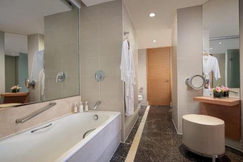 a bathroom with a tub and a toilet and a sink at Holiday Inn Chengdu Century City-EastTower in Chengdu