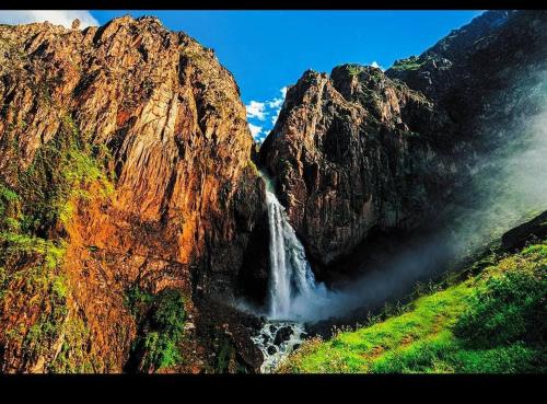 a waterfall on the side of a mountain at Fure Wassi Hostel in Cabanaconde