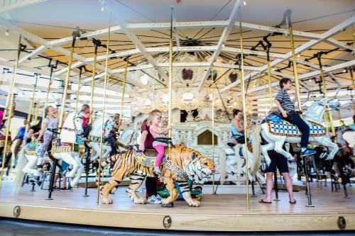 a group of people riding on a carousel at Holiday Inn Express Spokane Airport by IHG in Spokane