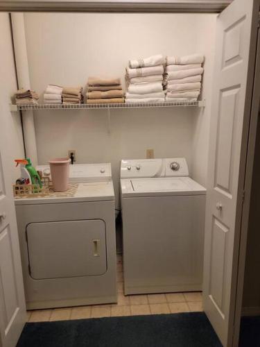 a laundry room with a washing machine and towels at Gulf Highlands 230 WSD in Panama City Beach