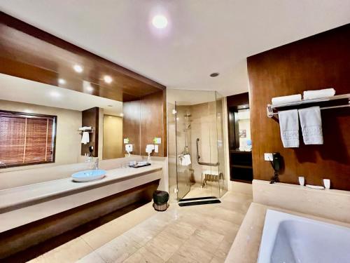 a bathroom with two sinks and a shower at AURORA Hotel Plaza in Bien Hoa