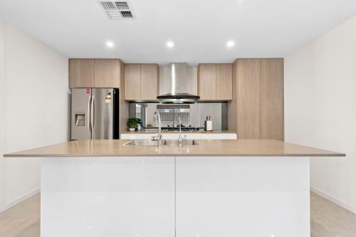 a kitchen with a sink and a refrigerator at Clover - The Split-Level Sanctuary in Payneham South in Norwood