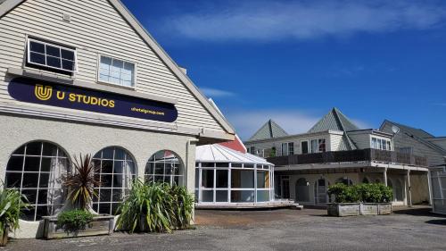 a building with a sign on the side of it at U Studios Paraparaumu Beach in Paraparaumu Beach