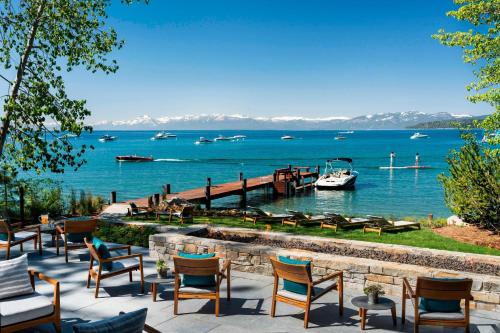 a group of chairs and a dock with boats in the water at The Ritz-Carlton, Lake Tahoe in Truckee