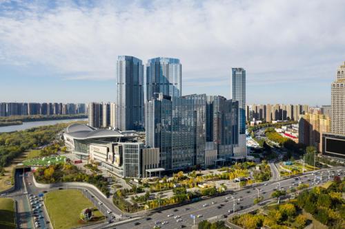 an aerial view of a city with tall buildings at New World Shenyang Hotel in Shenyang
