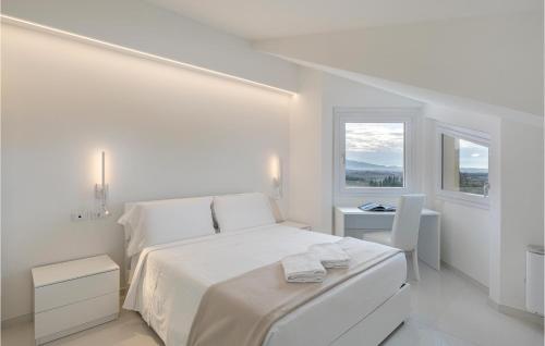 a white bedroom with a white bed and a window at Beautiful Home In Arezzo With Outdoor Swimming Pool, Wifi And 6 Bedrooms in Arezzo