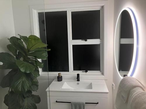 a bathroom with a sink and a window at Townhouse on Courtenay in New Plymouth