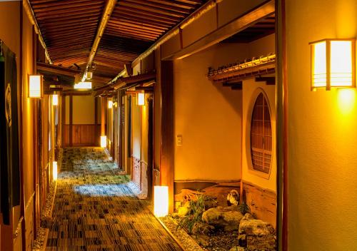 an empty hallway of a building with animals walking down it at Haiya in Awara