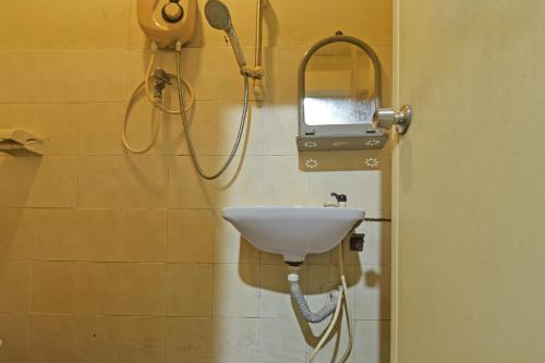 a bathroom with a sink and a shower at OYO 90794 Maple Hotel in Skudai