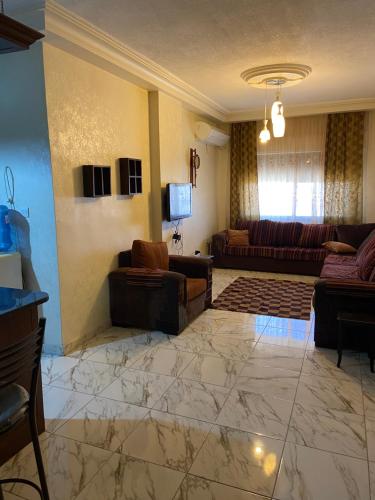 a living room with couches and a couch at شقة مفروشة للايجار في عمان شارع الجامعة الاردنية in Amman