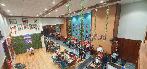 an overhead view of a crowd of people in a restaurant at Hotel 7-B in Chhatarpur