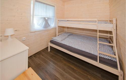 a bedroom with two bunk beds and a window at Gorgeous Home In Jaroslawiec With Kitchen in Jarosławiec