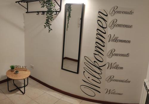 a mirror on a wall in a room with a table at Amici di Laura in Messina