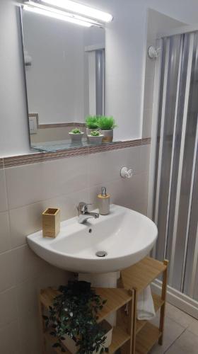 a bathroom with a white sink and a mirror at Amici di Laura in Messina