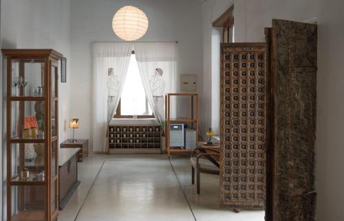 a living room with a room with a window and a mirror at La Closerie - Bay of Bengal in Puducherry