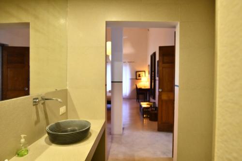a bathroom with a sink with a plate on a counter at La Closerie - Bay of Bengal in Puducherry