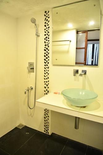 a bathroom with a sink and a shower at La Closerie - Bay of Bengal in Puducherry
