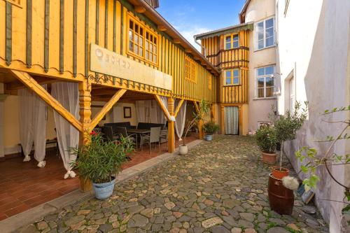 a yellow building with a table in a courtyard at Vila Antik in Nové Hrady