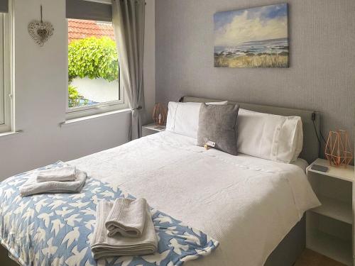 a bedroom with a bed with towels on it at Bell Tower in Berwick-Upon-Tweed