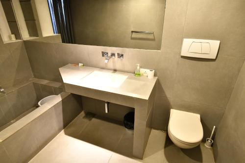 a bathroom with a sink and a toilet at La Closerie - Bay of Bengal in Puducherry