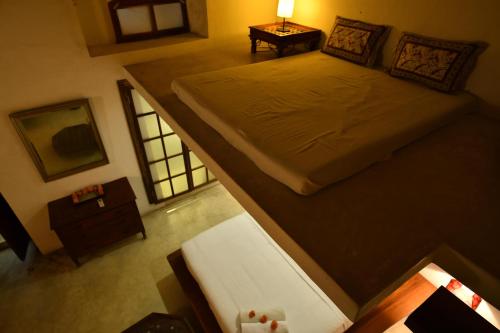 an overhead view of a bedroom with a large bed at La Closerie - Bay of Bengal in Puducherry