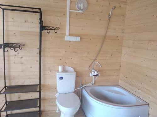 y baño de madera con aseo y ducha. en Namelis Karklėje, en Karklė