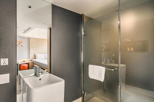 a bathroom with a sink and a shower at Orange Hotel - Ximen, Taipei in Taipei