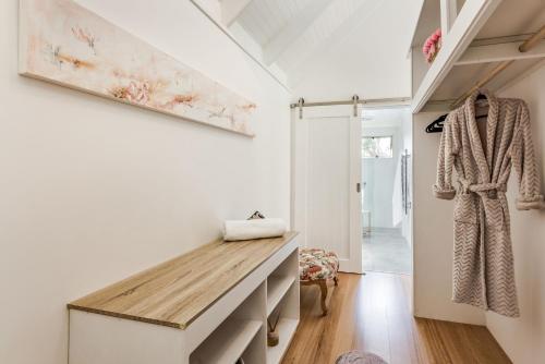 a hallway with a wooden bench in a house at Hideaway Studio in Dunsborough